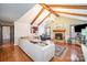 Bright living room with exposed beams, fireplace, and hardwood floors at 1304 Armstrong Ford Rd, Belmont, NC 28012