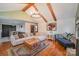 Spacious living room with exposed beams, a cozy fireplace, and hardwood floors at 1304 Armstrong Ford Rd, Belmont, NC 28012