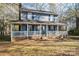 Front view of a charming two-story house with a large porch at 1316 Neal Hawkins Rd, Gastonia, NC 28056