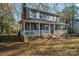 Two-story house with a large front porch and rocking chairs at 1316 Neal Hawkins Rd, Gastonia, NC 28056