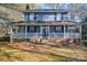 Two-story house with a front porch and rocking chairs at 1316 Neal Hawkins Rd, Gastonia, NC 28056