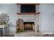 Brick fireplace with a rustic wooden mantle and decor at 1316 Neal Hawkins Rd, Gastonia, NC 28056