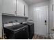 Bright laundry room with washer, dryer, and ample storage at 1316 Neal Hawkins Rd, Gastonia, NC 28056