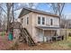 Two-story building with rustic exterior, wooden porch, and stairs at 1618 4Th St, Salisbury, NC 28144