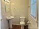 Bright bathroom features a pedestal sink, toilet, and a wood-look floor at 1618 4Th St, Salisbury, NC 28144