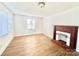 Bedroom with a decorative fireplace, wood trim and a large window with blinds at 1618 4Th St, Salisbury, NC 28144