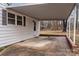 Attached carport featuring a concrete pad, brick trim, and access door to the house at 1618 4Th St, Salisbury, NC 28144