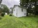 Side view of a white two-story home with green grass and a few small bushes at 1618 4Th St, Salisbury, NC 28144