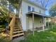 Two story home with a covered porch, wooden stairs and a small upper deck at 1618 4Th St, Salisbury, NC 28144