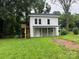 Two story home with a covered porch, wooden stairs and a small upper deck at 1618 4Th St, Salisbury, NC 28144