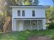 Two story home with a covered porch, wooden stairs and a small upper deck at 1618 4Th St, Salisbury, NC 28144