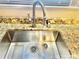 Close up of sink with granite counter tops and stainless steel faucet at 1618 4Th St, Salisbury, NC 28144