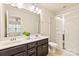 Bright bathroom featuring double sinks, a modern vanity, and glass enclosed shower at 1674 Fairntosh Dr, Fort Mill, SC 29715