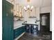 Stylish laundry room with dark green cabinets, marble countertops, and modern appliances at 19329 Watermark Dr # 261/262, Cornelius, NC 28031