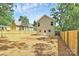 Back exterior with fenced in yard and a home featuring modern siding and lots of natural light at 204 N Yadkin Ave, Spencer, NC 28150