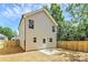 View of backyard featuring new wooden fence and concrete patio at 204 N Yadkin Ave, Spencer, NC 28150