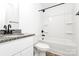 Bathroom with white vanity, granite countertop, and shower/tub combination at 204 N Yadkin Ave, Spencer, NC 28150