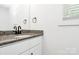 This bathroom features a granite countertop, modern white cabinet, a mirror, and stylish fixtures at 204 N Yadkin Ave, Spencer, NC 28150