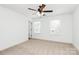 This bedroom features carpet flooring, white walls, and two windows for natural light and a ceiling fan at 204 N Yadkin Ave, Spencer, NC 28150