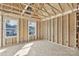 Under construction bedroom with two windows and wood framing at 204 N Yadkin Ave, Spencer, NC 28150