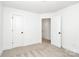 This bedroom features carpet flooring, white walls, and two white doors for entry and closet at 204 N Yadkin Ave, Spencer, NC 28150