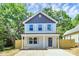 Charming two-story home featuring a covered front porch and new, light-colored wood fencing at 204 N Yadkin Ave, Spencer, NC 28150