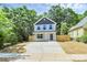 New construction home featuring a charming covered front porch, landscaping and fence at 204 N Yadkin Ave, Spencer, NC 28150