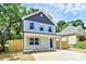 Charming two-story home with a welcoming front porch and a well-manicured front yard and gray and white siding at 204 N Yadkin Ave, Spencer, NC 28150