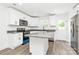 Modern kitchen featuring granite countertops, stainless steel appliances, and a kitchen island at 204 N Yadkin Ave, Spencer, NC 28150