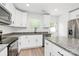 Modern kitchen featuring granite countertops, stainless steel appliances, and ample cabinet space at 204 N Yadkin Ave, Spencer, NC 28150