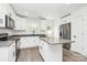 Modern kitchen featuring granite countertops, stainless steel appliances, and a kitchen island at 204 N Yadkin Ave, Spencer, NC 28150