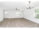 Open floor plan with stylish light fixtures, modern light-colored floors, and abundant natural light at 204 N Yadkin Ave, Spencer, NC 28150