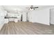 Open floor plan with modern, light-colored flooring connecting the living room and kitchen at 204 N Yadkin Ave, Spencer, NC 28150
