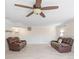 Finished basement with two leather recliners and ceiling fan at 220 Augusta Dr, Statesville, NC 28625