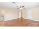 Hardwood floor bedroom with ceiling fan and access to bathroom at 220 Augusta Dr, Statesville, NC 28625