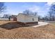 White detached garage with concrete slab and partial brick foundation at 220 Augusta Dr, Statesville, NC 28625