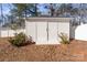 White storage shed in backyard with landscaping at 220 Augusta Dr, Statesville, NC 28625