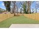A large, newly fenced backyard with fresh grass and landscaping at 2221 Edison St, Charlotte, NC 28206