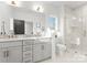 Modern bathroom with double vanity, marble counters, and a sleek glass-enclosed shower at 2221 Edison St, Charlotte, NC 28206