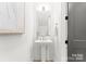 Well-lit powder room featuring elegant fixtures, a pedestal sink, and modern decor at 2221 Edison St, Charlotte, NC 28206