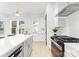 Bright kitchen with stainless steel appliances, sleek white cabinetry, and quartz countertops at 2221 Edison St, Charlotte, NC 28206