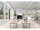 Bright living room featuring a fireplace, light wood floors, and sliding glass doors to the backyard at 2221 Edison St, Charlotte, NC 28206
