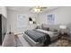 Bright bedroom with hardwood floors, ceiling fan, and large windows at 27097 Cove Ln, Tega Cay, SC 29708