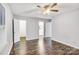 Well-lit bedroom with hardwood floors, ceiling fan, and access to bathroom at 27097 Cove Ln, Tega Cay, SC 29708