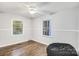 Bedroom with hardwood floors, ceiling fan, and window at 27097 Cove Ln, Tega Cay, SC 29708