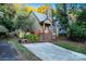 A charming two-story home with a stone fireplace and red stairs, daytime view at 27097 Cove Ln, Tega Cay, SC 29708