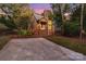 Two-story house with brick accents and a stone chimney, nestled in a wooded area at 27097 Cove Ln, Tega Cay, SC 29708