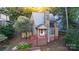 A charming two-story home with a stone fireplace and red stairs at 27097 Cove Ln, Tega Cay, SC 29708