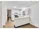 Galley kitchen with white cabinets, built-in appliances, and tile floors at 27097 Cove Ln, Tega Cay, SC 29708