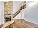 Living room showcasing a stone fireplace and staircase to upper level at 27097 Cove Ln, Tega Cay, SC 29708